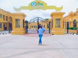 a woman standing in front of Apapa Amusement Park